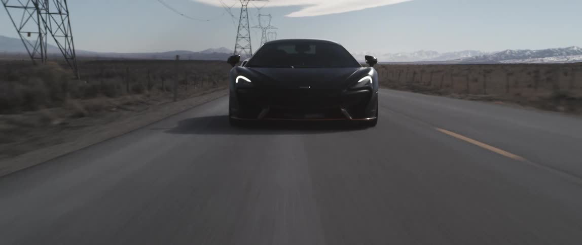 A car driving up behind another one on a road