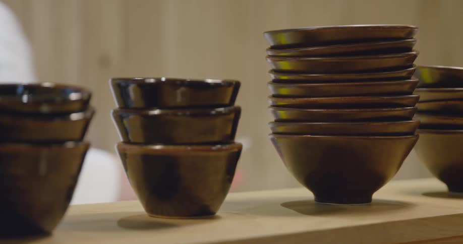 A server walks past a row of bowls