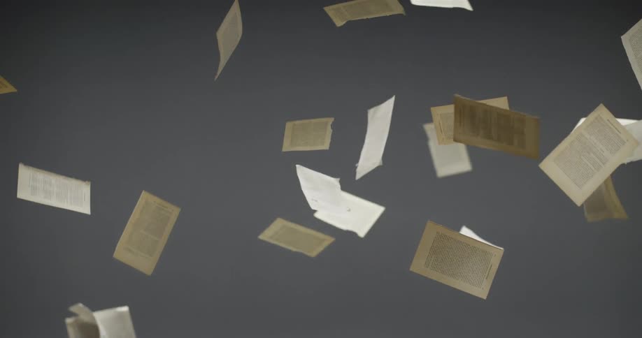Pages torn from book flutter as they fall against a grey background