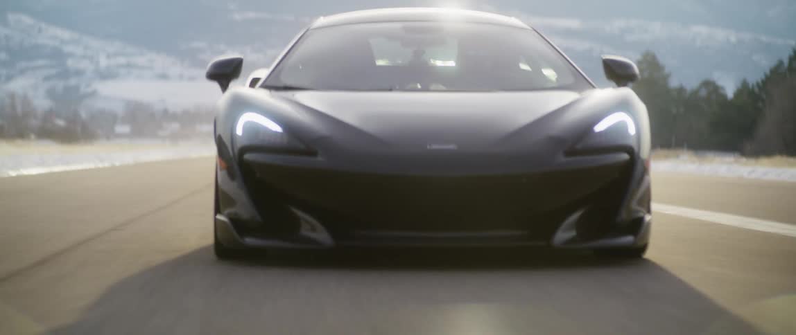 Two sports cars race down the highway