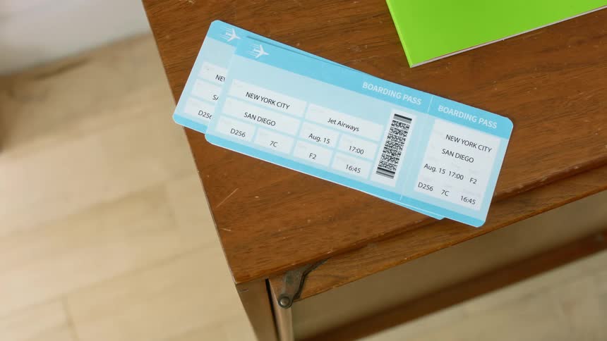 Two boarding passes sit on a coffee table