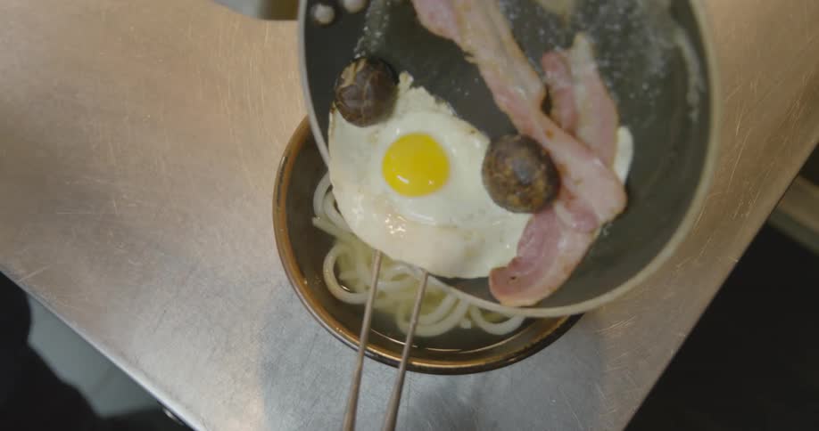 A noodle bowl is served and taken away