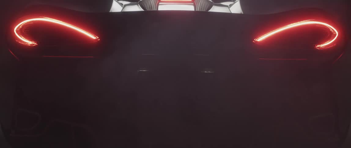 Rear lights turn on with exhaust coming out of the back of a sportscar