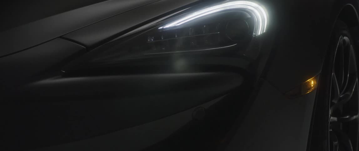 Headlight of a powerful black sports car