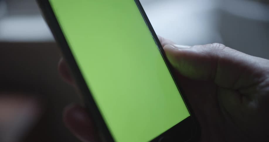 A man holds his smartphone in one hand