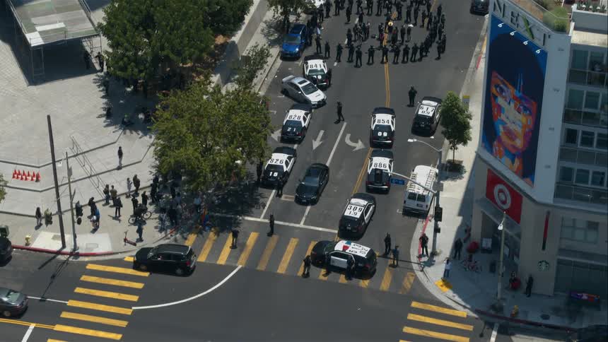A group of police officers surrounding people in a street