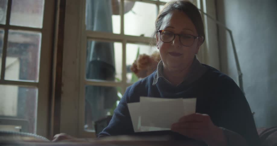 A woman is looking at photographs
