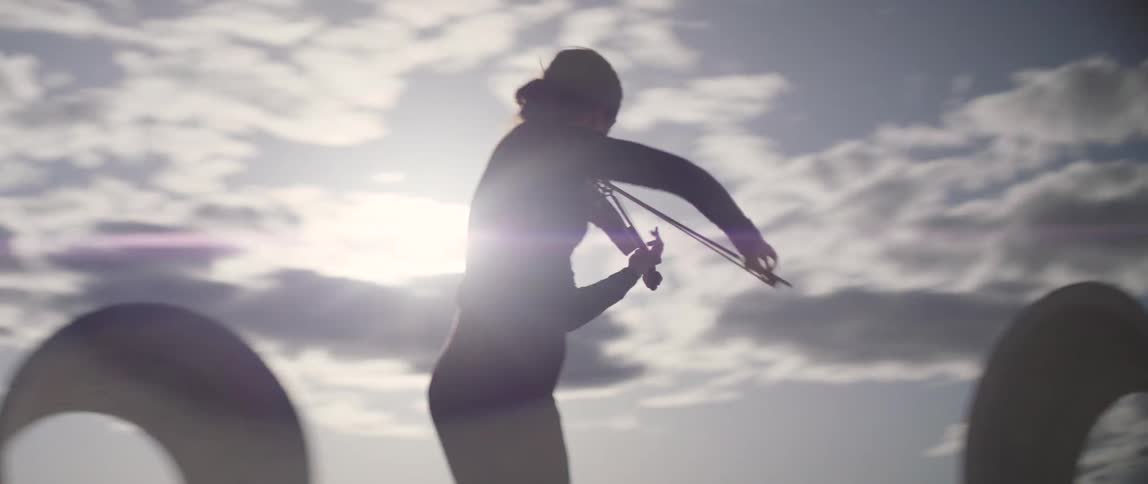 A woman playing violin outdoors