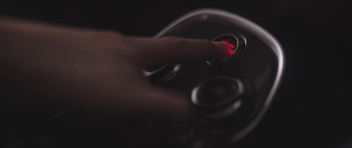 A person presses the button in the vehicle