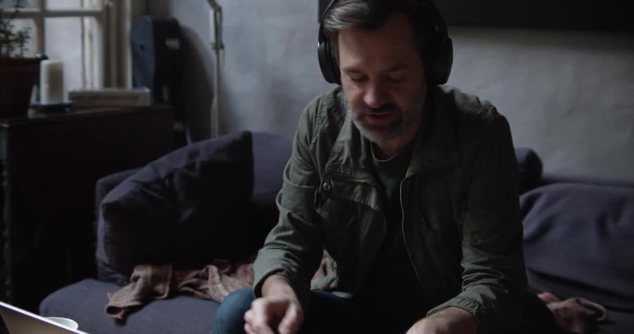 A man talks on his laptop at home