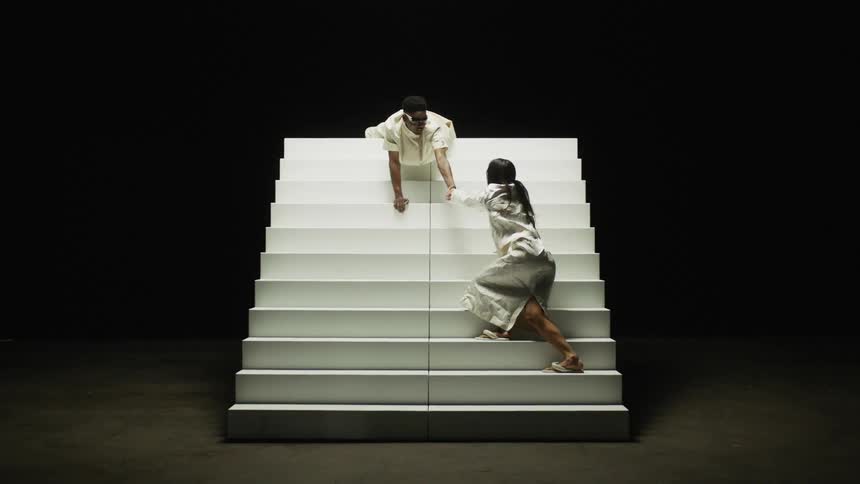 A man and woman are sitting on a staircase together