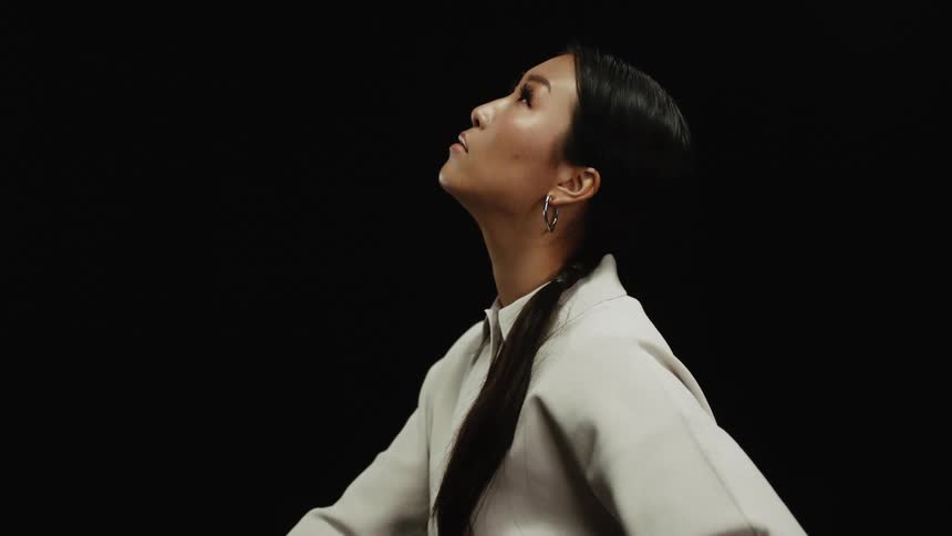 A young asian woman looks around as she models