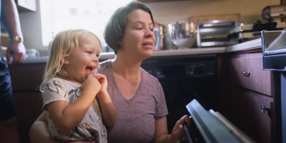 A woman and child watching food being cooked