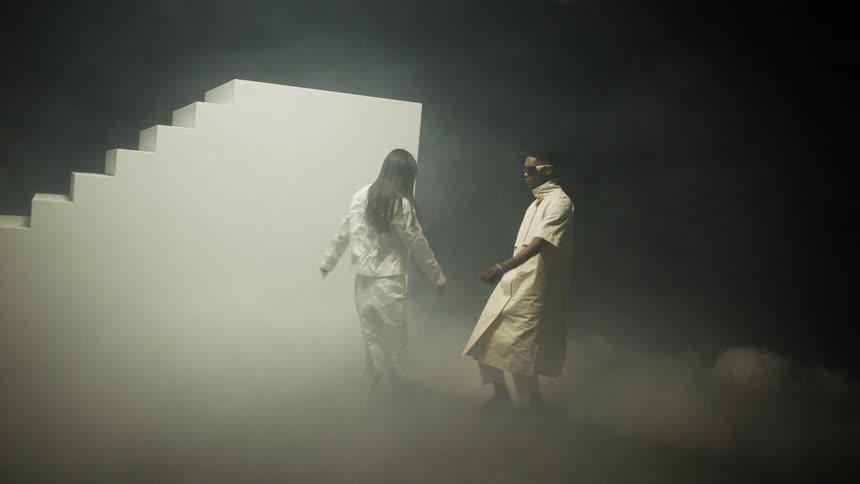 Man and woman are dancing outdoors and wearing glasses