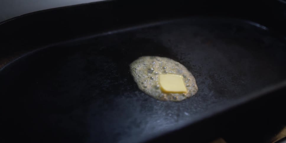 A close up of butter melting in a pan