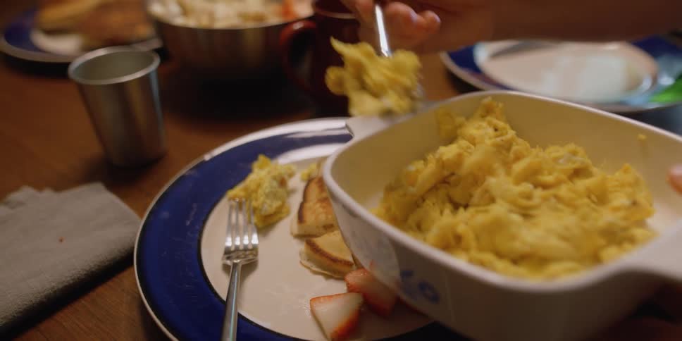 A person serves food on to a plate
