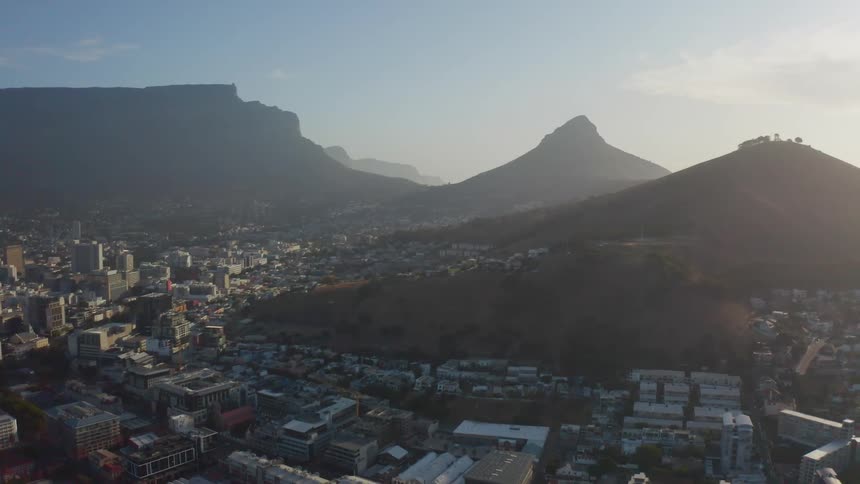Aerial view of a city at the foot of the mountains in the morning