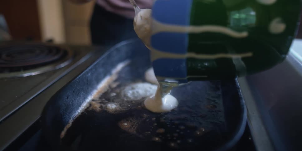 A close up of a person cooking pancakes