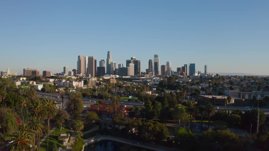 Vehicles drive on the freeway by the city