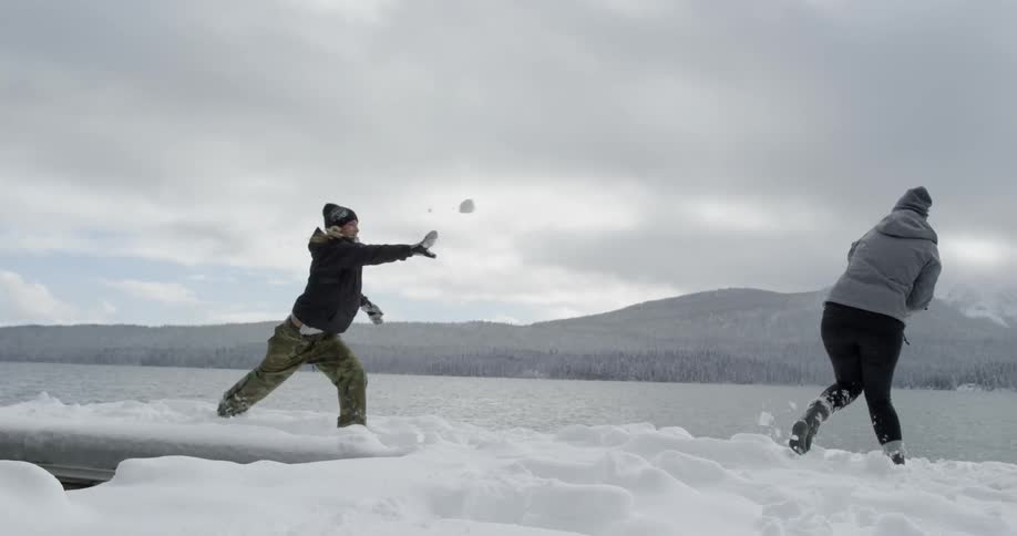 Two women having a snowball fight