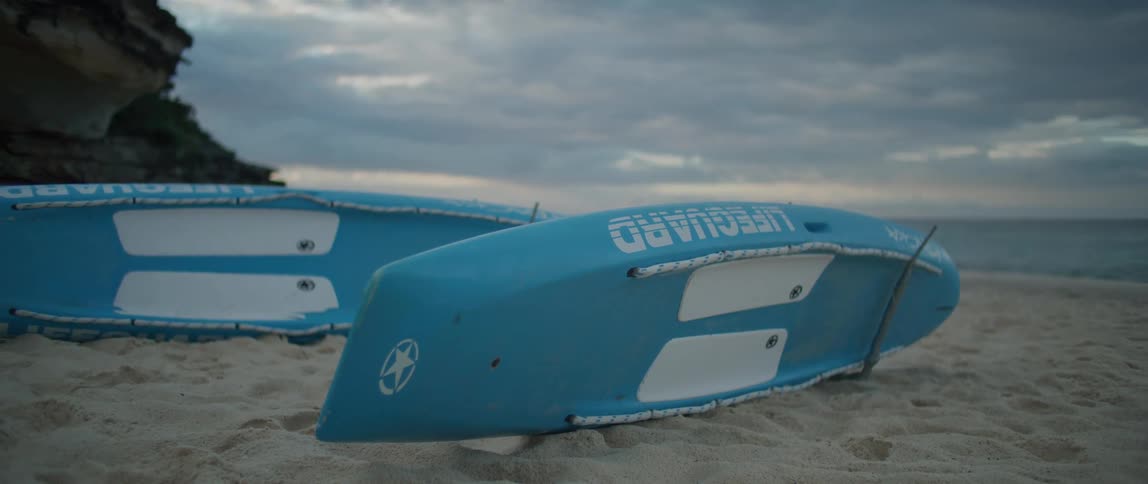 Two boats are left on the sandy beach