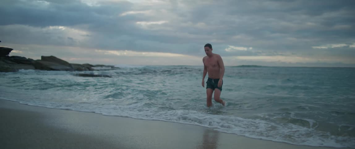A man walks out of the ocean
