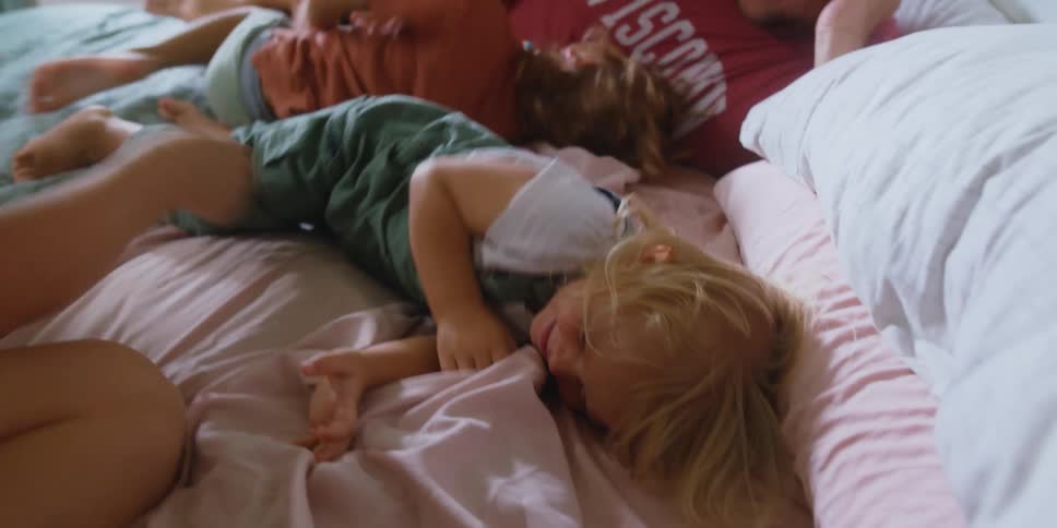 Mother and father are playing with their kids indoors