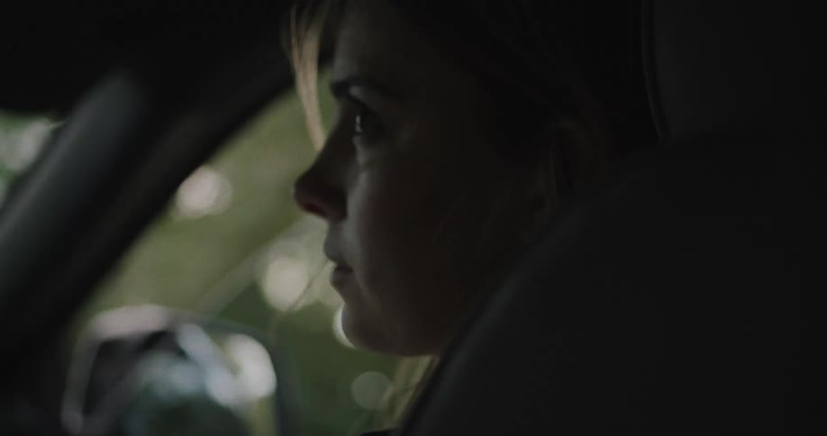 A woman is riding in the vehicle