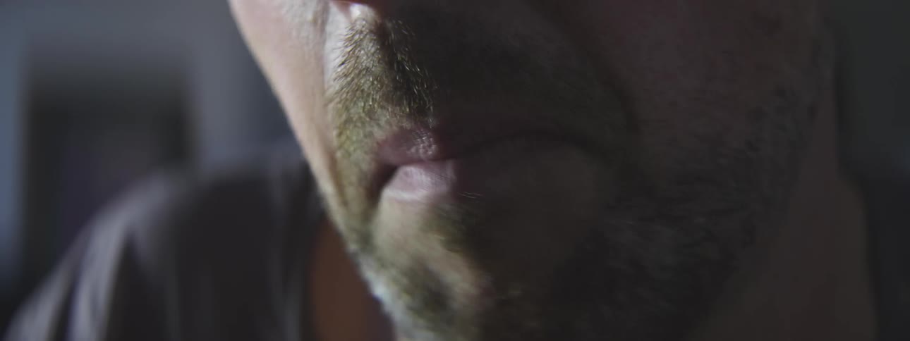 A close up of a mans mouth that is eating