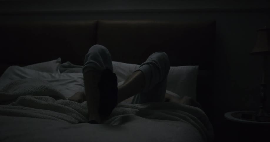 A man is laying in bed at night