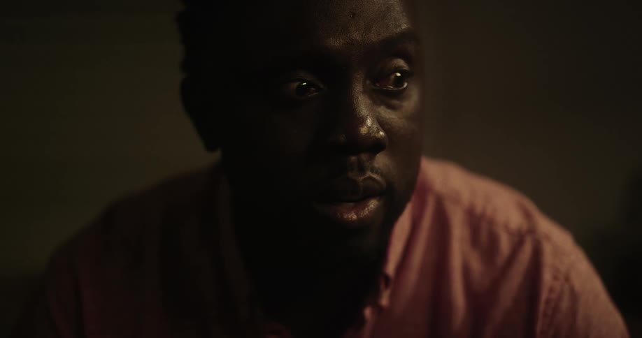 A man turns his head and looks anxiously around