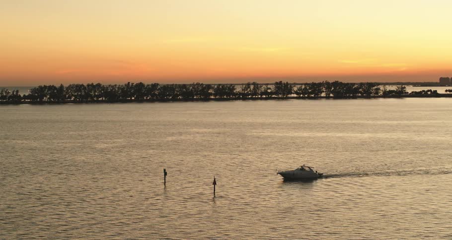 Boat driving at sunset
