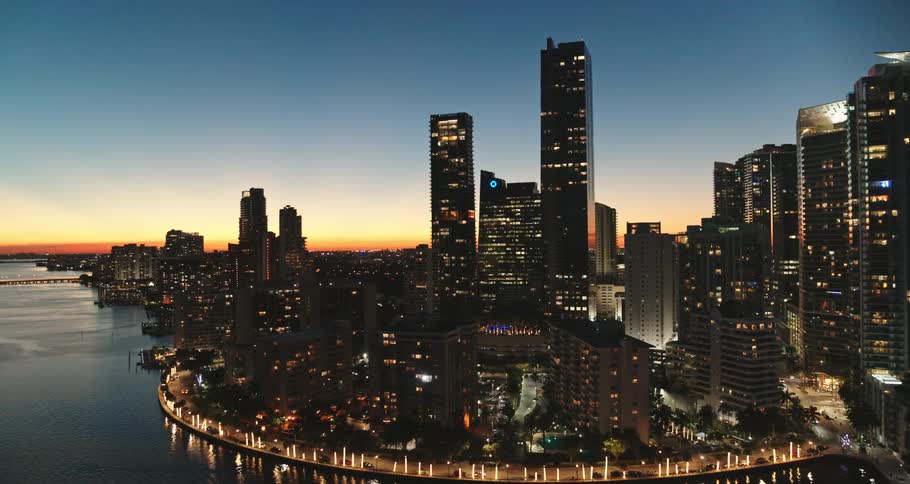 A city near the coast with buildings and skyscrapers with the sky and clouds in the background