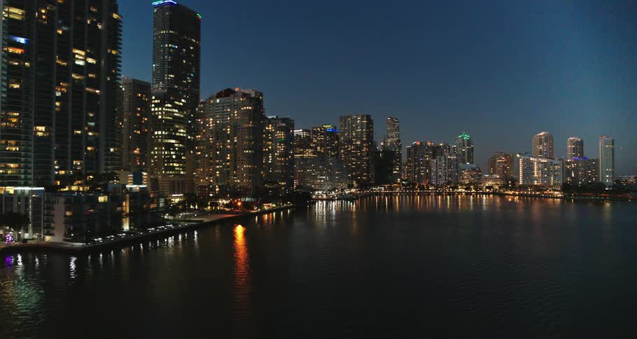 A city near the coast with buildings and skyscrapers with the sky and clouds in the background