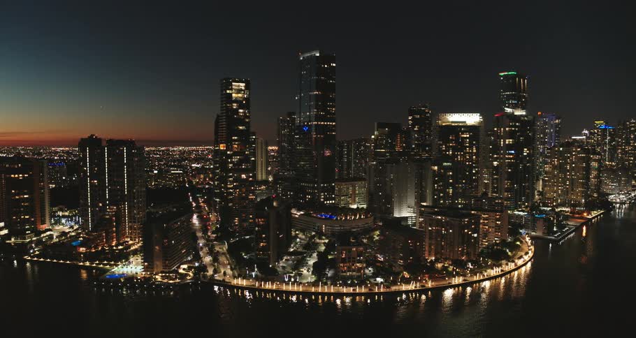 A city near the coast with buildings and skyscrapers with the sky and clouds in the background
