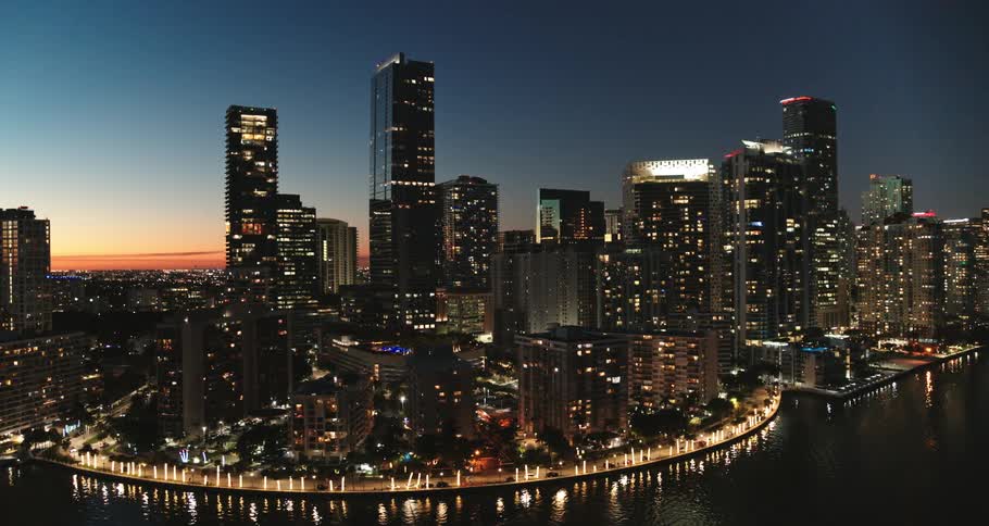 Miami skyline is lit up as the sun sets