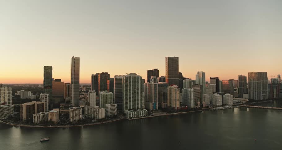 City buildings along a river at sunset