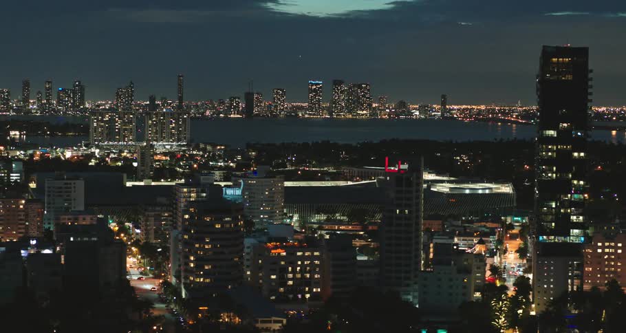 A city on a river is shown at night time fully lit up