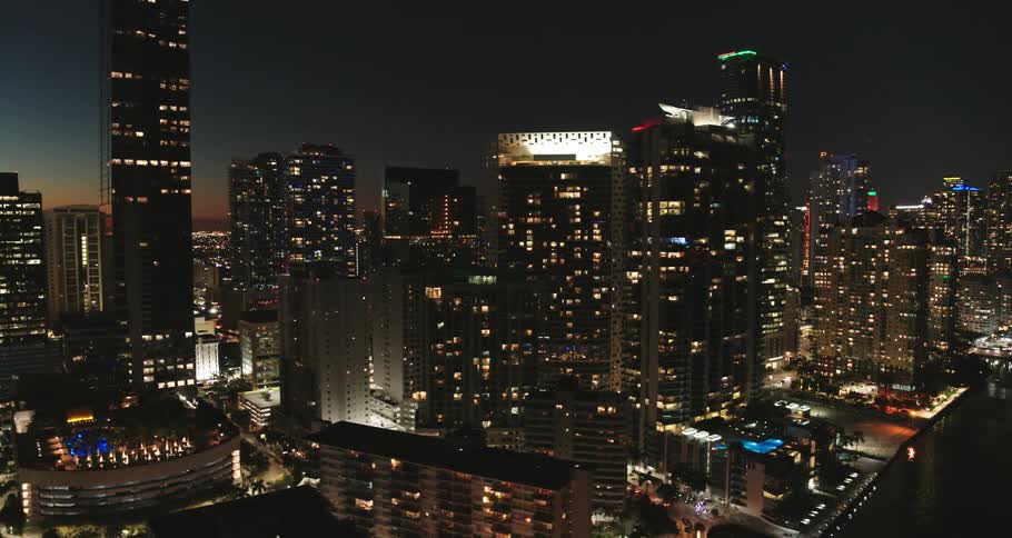 A city is lit up as the sun goes down