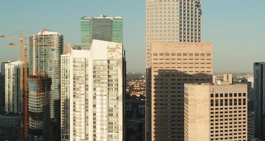 Tall skyscrapers rise into the smoggy sky of a large city area