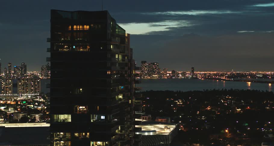 A city near the coast with buildings and skyscrapers with the sky and clouds in the background