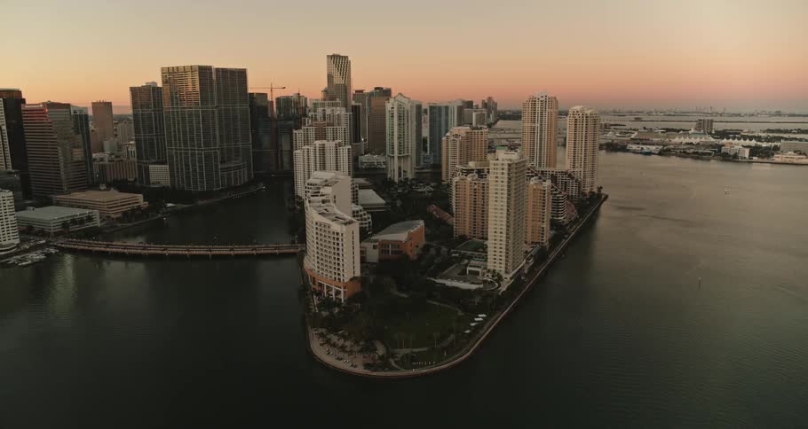 A coastal city with buildings and skyscrapers with the sky and clouds in the background