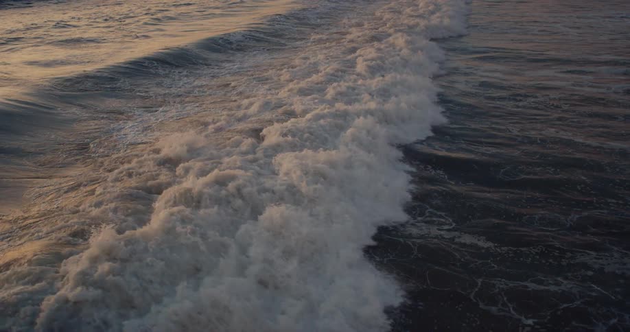 Waves are moving fast in the ocean at dusk