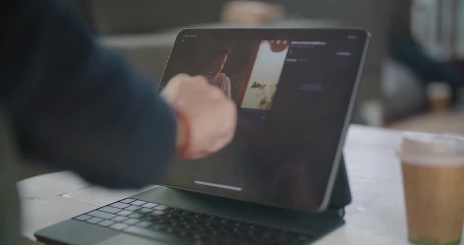 A man is looking at a laptop in his house