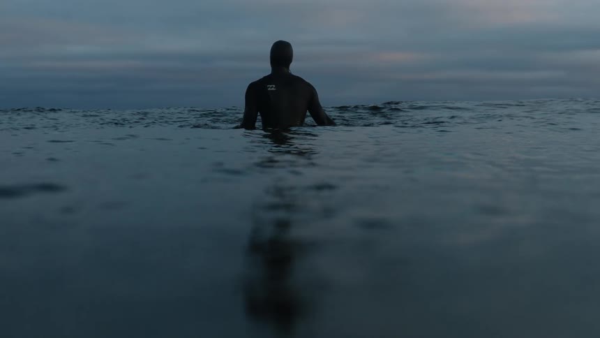 A man is wading in the water