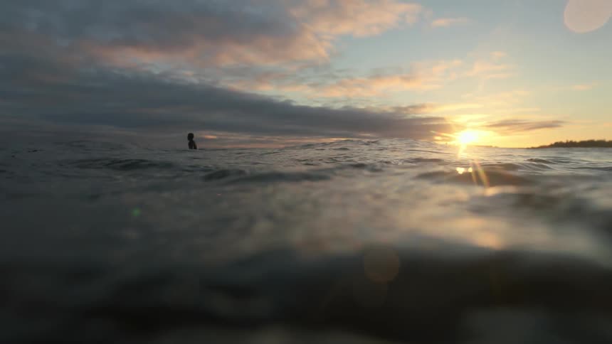 A man stands in wavy water