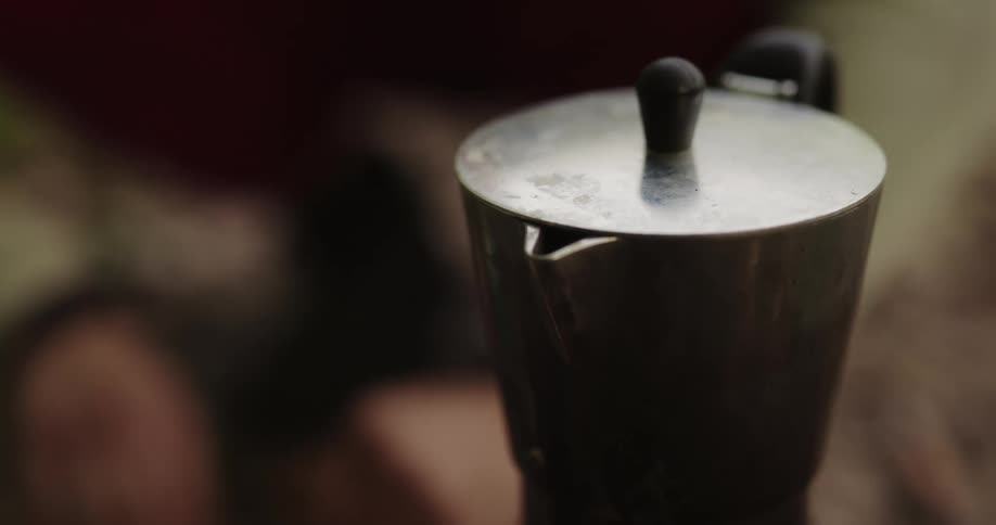A camper picks up a coffee pot