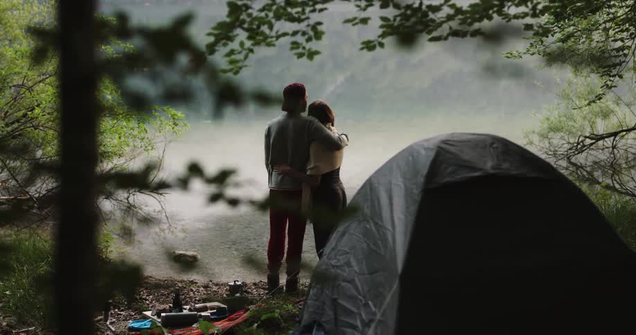 A man and woman are standing by a tent in spring