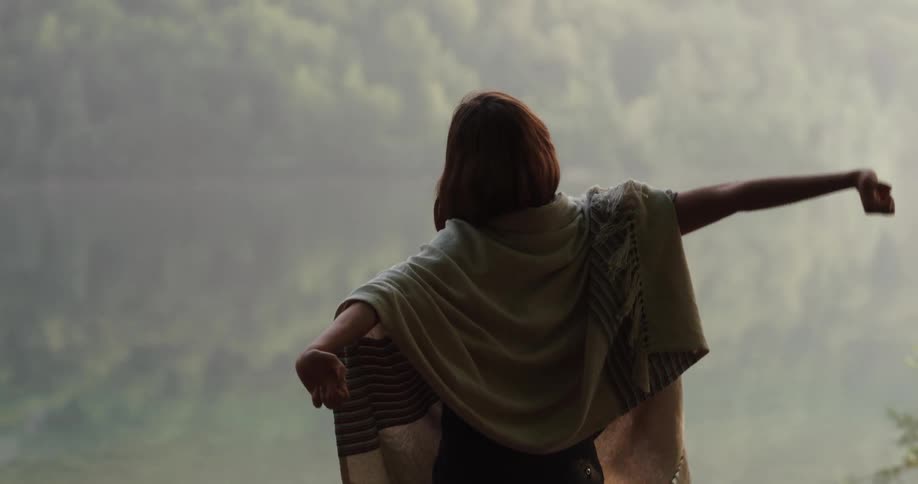 A woman stretching and relaxing outdoors