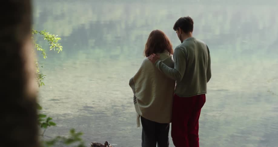 Man and woman are standing by the river together